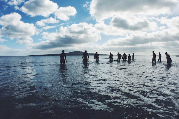 People walking into the sea